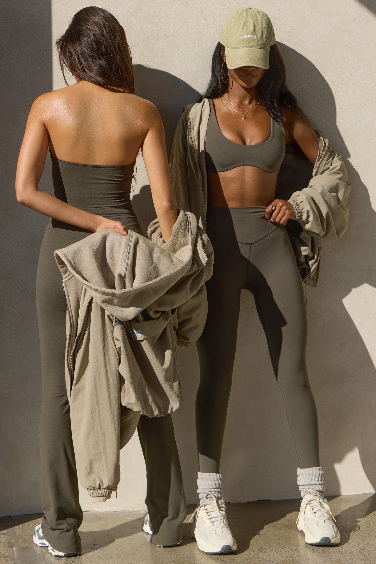 Two models posing sueded carob tops and leggings