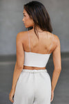 Back view of model posing in the fitted cropped sueded yuma Contour Corset tank top with delicate corded straps, a curved hem and paneling on the bodice