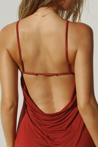 Close up back view of model posing in the relaxed fit cherry modal Cowl Back Mini Dress with a v-neckline, thin adjustable straps, A-line silhouette, and an open back with a draped cowl detail