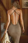 Back view of model posing in the fitted  sepia washed rib Cross Back Midi Dress with an asymmetrical hem, a low, scoop back and thin adjustable straps that criss cross in the back