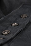 Close up detail view of the custom JOAH BROWN buttons on the front of the washed black Vintage Henley Long Sleeve top