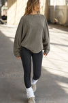 Full body front view of model posing in the relaxed fit oakmoss sherpa Drop Shoulder Pullover sweatshirt with an exaggerated crew neckline, dropped shoulders and a custom Joah Brown Logo Patch on the left sleeve 