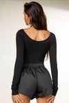 Back view of model posing in the fitted, light weight black modal Boatneck Long Sleeve with boat neckline and scoop back