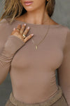 Close up detail front view of model posing in the fitted, light weight sienna modal Boatneck Long Sleeve with a boat neckline