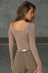 Back view of model posing in the fitted, light weight sienna modal Boatneck Long Sleeve with boat neckline and scoop back