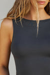 Close up detail front view of model posing in the fitted, lightweight black modal Boatneck Tank top with a boat neckline