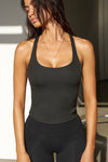 Front view of model posing in the vintage black flexrib Classic Racerback Tank with a scoop neckine and racerback silhouette. 
