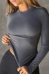 Close up front view of model posing in the fitted and stretchy smoke rib Crewneck Long Sleeve with a banded crew neckline