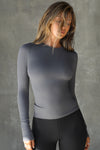 Front view of model posing in the fitted and stretchy smoke rib Crewneck Long Sleeve with a banded crew neckline