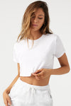 Front view of model posing in the soft cropped white modal Deconstructed Crop Tee with a crew neckline and exposed seams