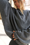 Close up front view of model posing in the relaxed fit storm sherpa Drop Shoulder Pullover sweatshirt with an exaggerated crew neckline, dropped shoulders and a custom Joah Brown Logo Patch on the left sleeve 