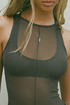 Close up detail front view of model posing in the reversible full-length sheer graphite mesh Bare Tank wearing it reversed so the front features a high neckline, with a vertical seam detail down the middle