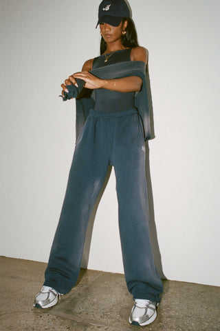 Full body front view of model posing in the fitted, lightweight navy modal Boatneck Tank top with a boat neckline