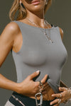 Close up side view of model posing in the fitted, lightweight shadow modal Boatneck Tank top with a boat neckline