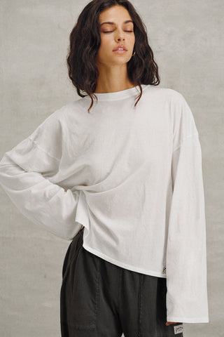 Front view of model posing in the relaxed fit, lightweight optic white classic cotton Boxy Crew Long Sleeve top with a crew neckline, dropped shoulders and oversized silhouette