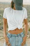 Front view of model posing outside in the desert in the relaxed fit white modal Boyfriend Tee with a crew neckline