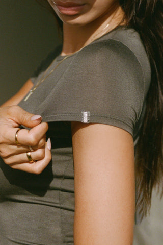 Close up detail side view of model posing in the lightweight and fitted spruce modal Classic Crew Tee shirt with a classic crew neckline and short sleeves.