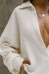 Close up detail front view of model posing in the oversized natural luxe knit Deep V Pullover with a plunging collared neckline and dropped shoulders