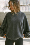 Front view of model posing in the relaxed fit storm sherpa Drop Shoulder Pullover sweatshirt with an exaggerated crew neckline, dropped shoulders and a custom Joah Brown Logo Patch on the left sleeve 