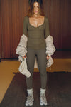 Full body front view of model posing in the fitted woodland rib Henley Long Sleeve with a notch in the scoop neckline