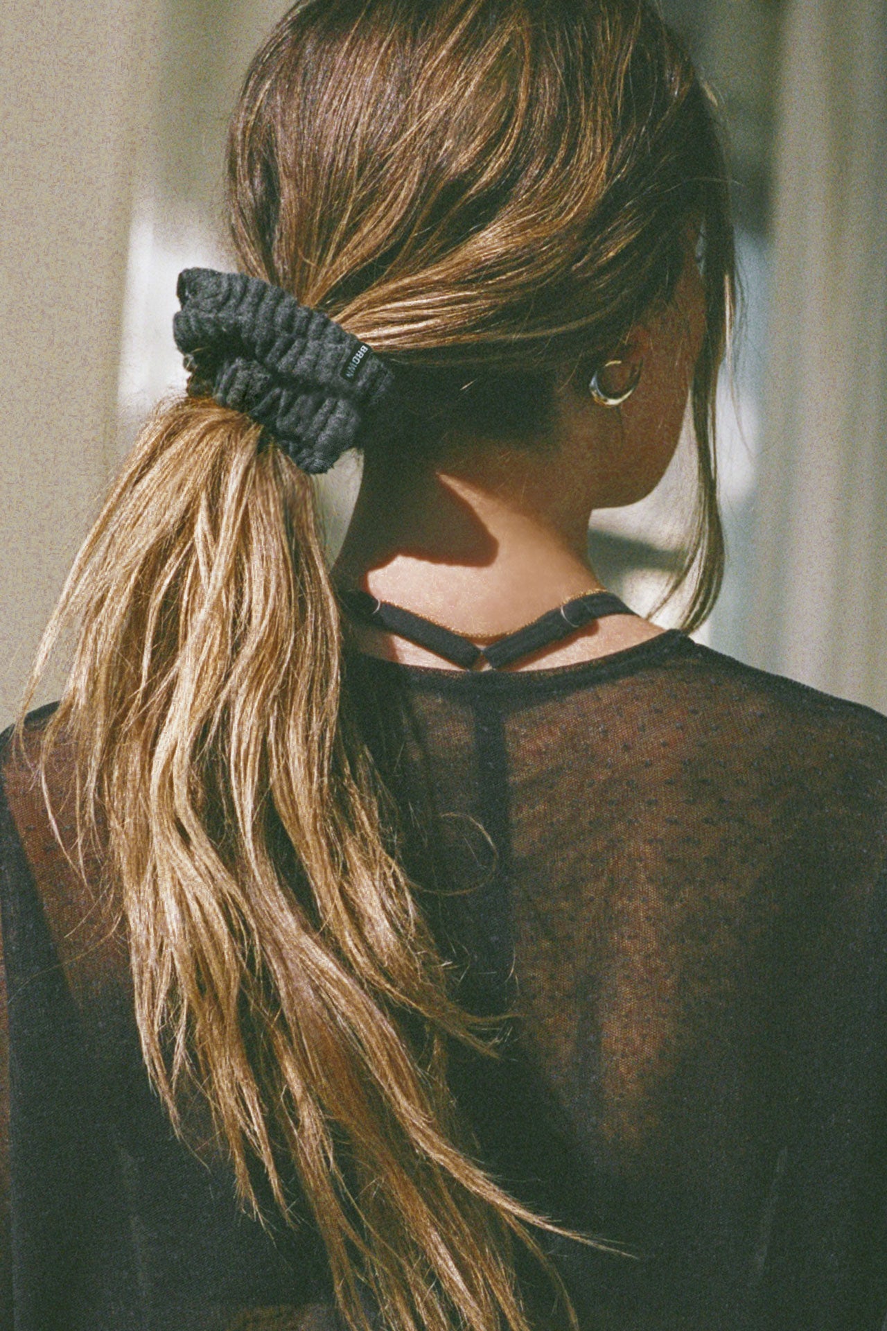 Back view of model wearing the soft and stretchy ink luxe knit Knit Scrunchie wrapped around her pony tail