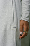 Close up detail view o a model's hand resting against the relaxed fit pearl grey french terry Oversized Straight Leg Jogger with an elastic waistband, hidden drawstring, pocket details and a custom Joah Brown patch