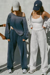 Two modes posing in a heritage washed navy french terry sweat set and a white sueded halter top and pearl french terry bottom set. 