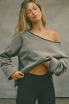 Front view of model posing in the oversized washed sage french terry Slouchy Pullover Sweatshirt with a wide, off-the-shoulder neckline and a JOAH BROWN logo patch on the right sleeve