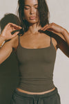 Front view of model posing in the soft and stretchy sueded carob Smoothing Cami with a scoop neckline and thin straps