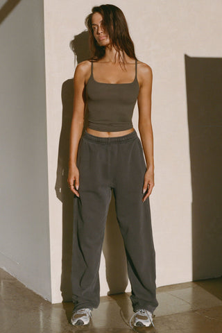 Full body front view of model posing in the soft and stretchy sueded carob Smoothing Cami with a scoop neckline and thin straps