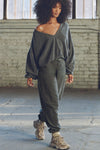 Full body front view of model posing in the slouchy storm sherpa V Neck Pullover sweatshirt with a wide V-neckline that can be worn on or off the shoulders.
