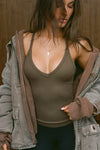 Front view of model posing in the fitted stretchy woodland flexrib V Neck Racerback Tank with a deep v neckline and thin straps