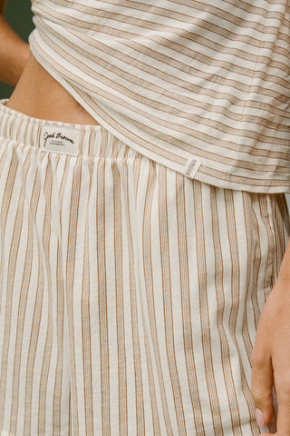 Close up detail front view of model posing in the tobacco stripe classic cotton Vintage Tee with a crew neckline and relaxed silhouette
