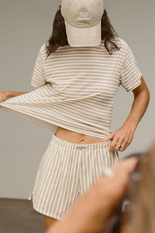 Front view of model posing in the tobacco stripe classic cotton Vintage Tee with a crew neckline and relaxed silhouette