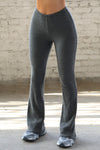 Front view of model from the waist down posing in the mid-rise fitted charcoal luxe knit Fitted Mini Flare Pant with a slightly flare leg
