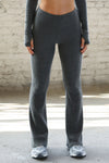 Front view of model from the waist down posing in the mid-rise fitted charcoal luxe knit Fitted Mini Flare Pant with a slightly flare leg