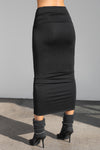 Back view of model from the waist down posing in the fitted black model Foldover Maxi Skirt with an adjustable fold over waistband