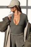 Front view of model wearing the form fitting mineral flexrib Invisible Zip Long Sleeve top with a 3/4 front invisible zipper and a crew neckline