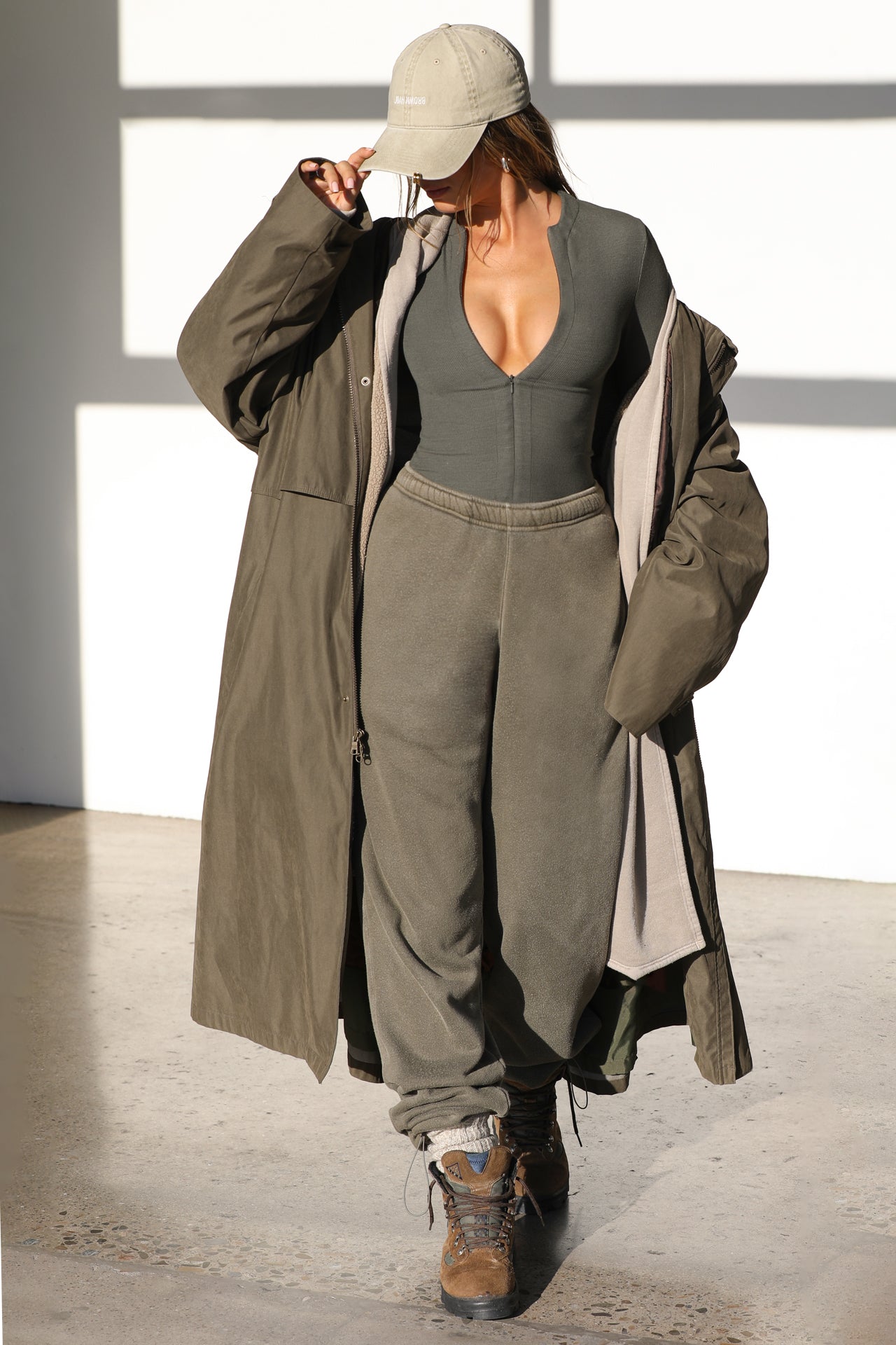 Full body front view of model wearing the form fitting mineral flexrib Invisible Zip Long Sleeve top with a 3/4 front invisible zipper and a crew neckline