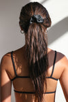 Back view of model wearing the midnight Silk Scrunchie hair tie around her hair in a high ponytail