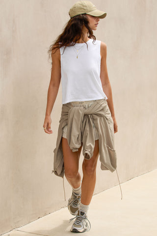 Full body front view model posing in the relaxed fit optic white cotton Muscle Tank with a crew neckline