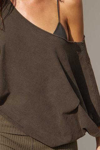 Close up detail front view of model posing the sheer, minimal coverage graphite mesh Triangle Bralette with thin and glossy adjustable elastic straps