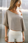 Front view of model posing in the relaxed fit and boxy sandstone cotton Off Shoulder Tee with a wide scoop neckline that can be worn off the shoulders.