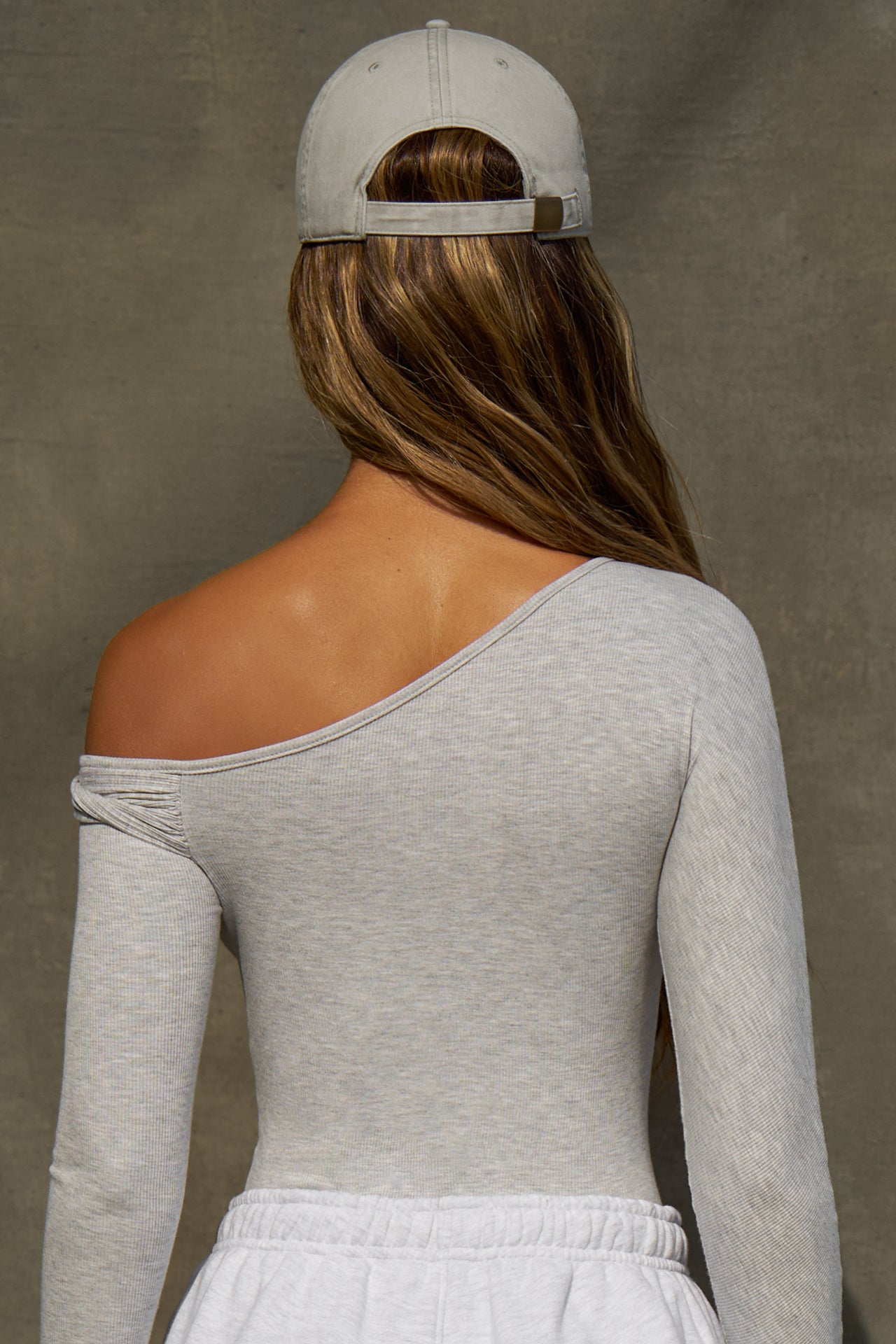 Back view of model wearing the six-panel sahara Official Cap with a curved brim and adjustable strap