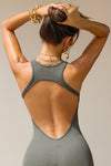 Close up back view of model posing in the mini, fitted mineral rib Open Back Dress with a low scoop neckline and open back