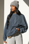 Front view of model posing in the relaxed fit washed navy french terry Oversized Crew Pullover sweatshirt with dropped sleeves and a ribbed crew neckline