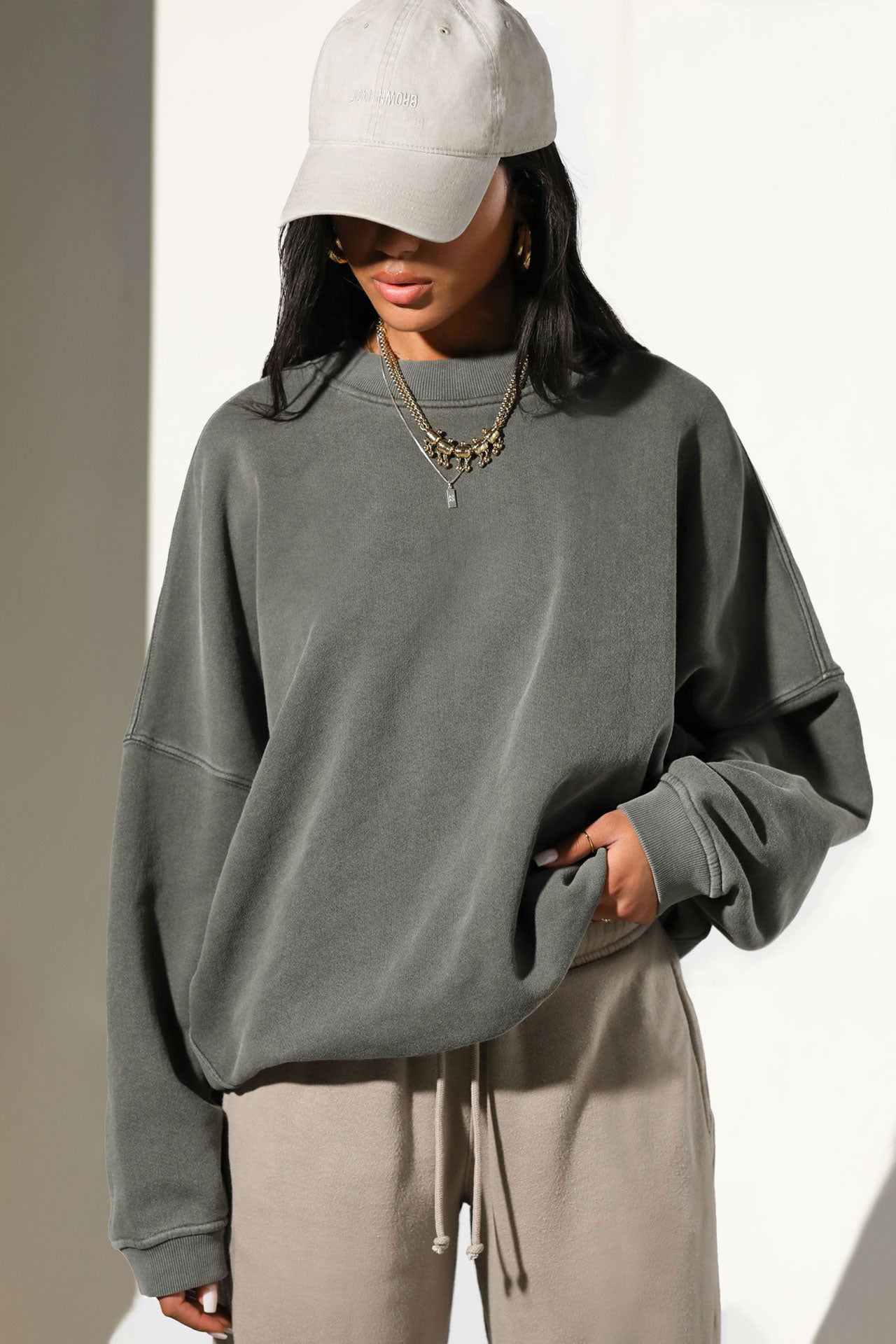 Front view of model posing in the relaxed fit washed sage french terry Oversized Crew Pullover sweatshirt with dropped sleeves and a ribbed crew neckline