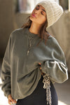 Front view of model posing in the relaxed fit washed sage french terry Oversized Crew Pullover sweatshirt with dropped sleeves and a ribbed crew neckline