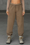 Front view of model from the waist down wearing the oversized loose fit cocoa french terry Oversized Jogger with an elastic waistband and ankle cuffs
