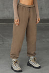 Front view of model from the waist down wearing the oversized loose fit cocoa french terry Oversized Jogger with an elastic waistband and ankle cuffs
